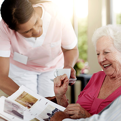 Nurse helping old woman (photo)