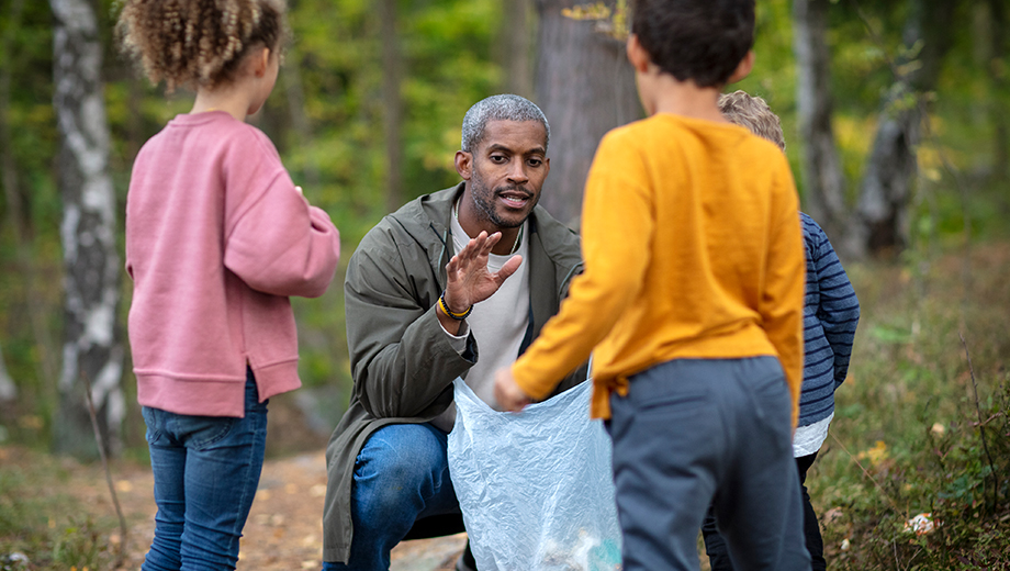 Man talking to kids in the woods